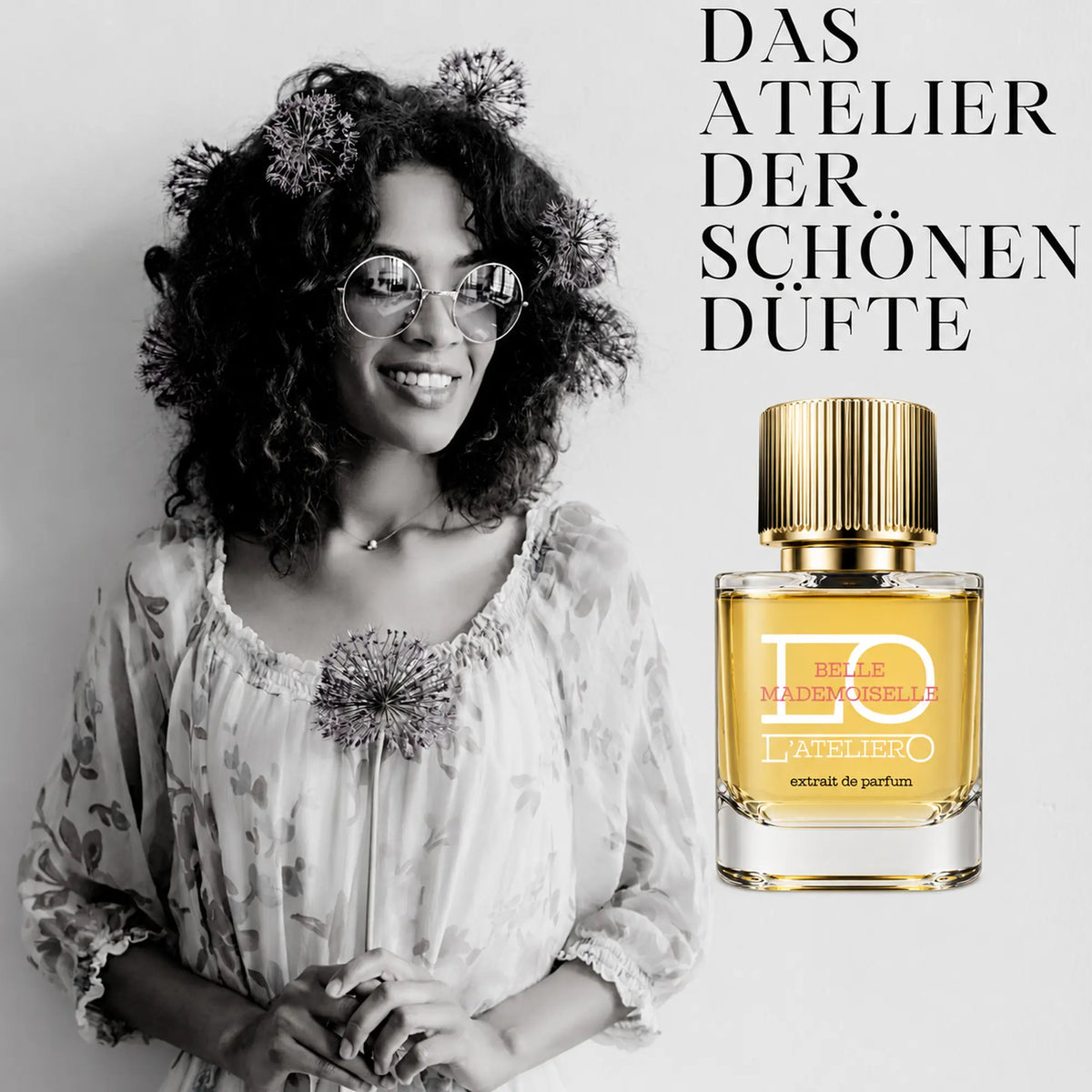 L’ATELIERO Belle Mademoiselle Extrait de Parfum 50 ml: Flakon neben einer lächelnden Frau mit lockigem Haar, Sonnenbrille und Blumen.